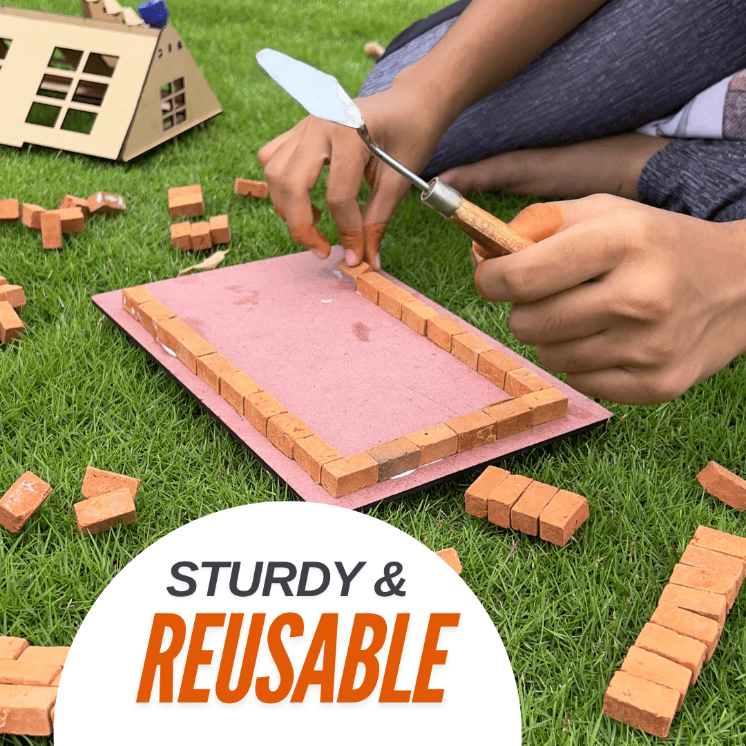 Child building a miniature brick wall outdoors